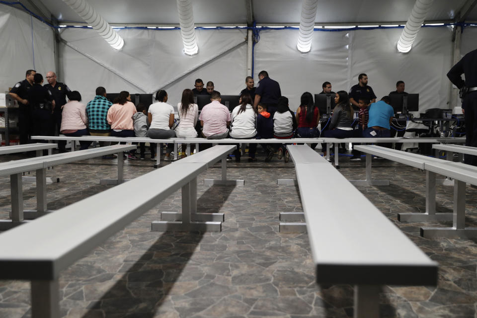 Migrants who are applying for asylum in the United States go through a processing area at a new tent courtroom at the Migration Protection Protocols Immigration Hearing Facility, Tuesday, Sept. 17, 2019, in Laredo, Texas. (AP Photo/Eric Gay)