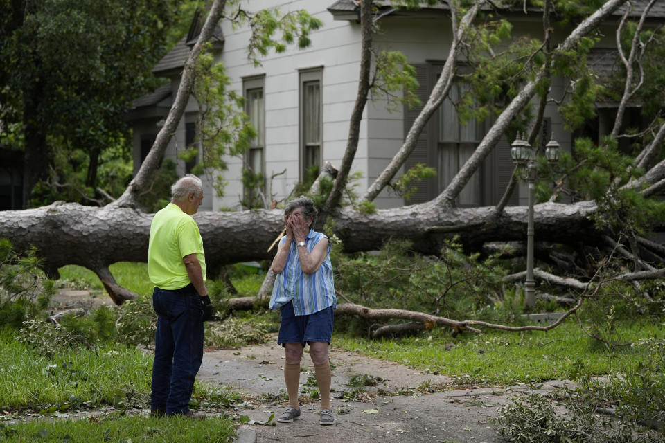 Jackie Jecmenek, right, talks with city worker Bobby Head as she stands in front of her neighbor's home after Beryl passed, Monday, July 8, 2024, in Bay City, Texas. (AP Photo/Eric Gay)