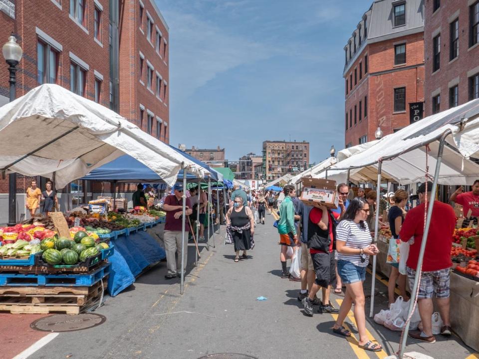 People shopping at a busy outdoor market.