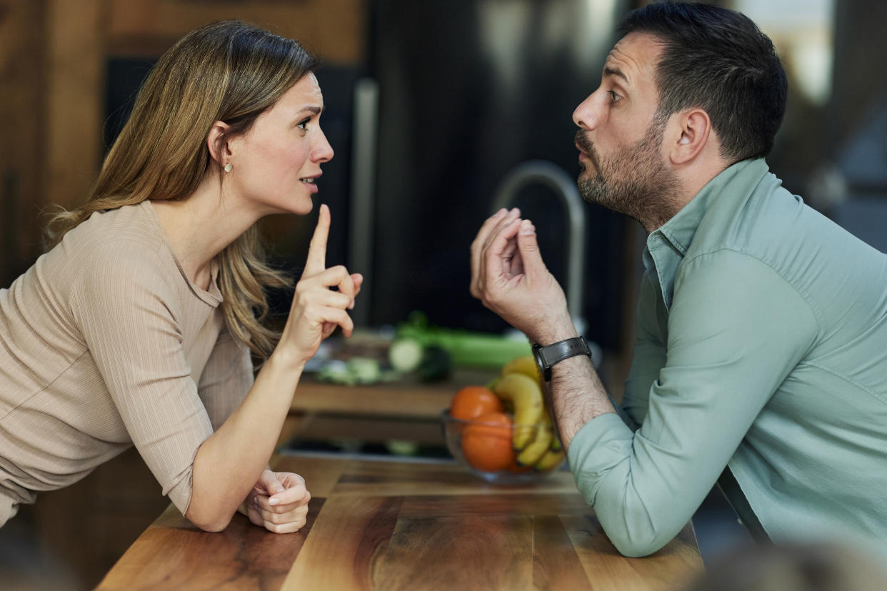 Couple arguing in kitchen – choosing to break up with someone in person. (Getty Images)