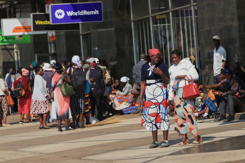 People queue to withdraw cash in Harare
