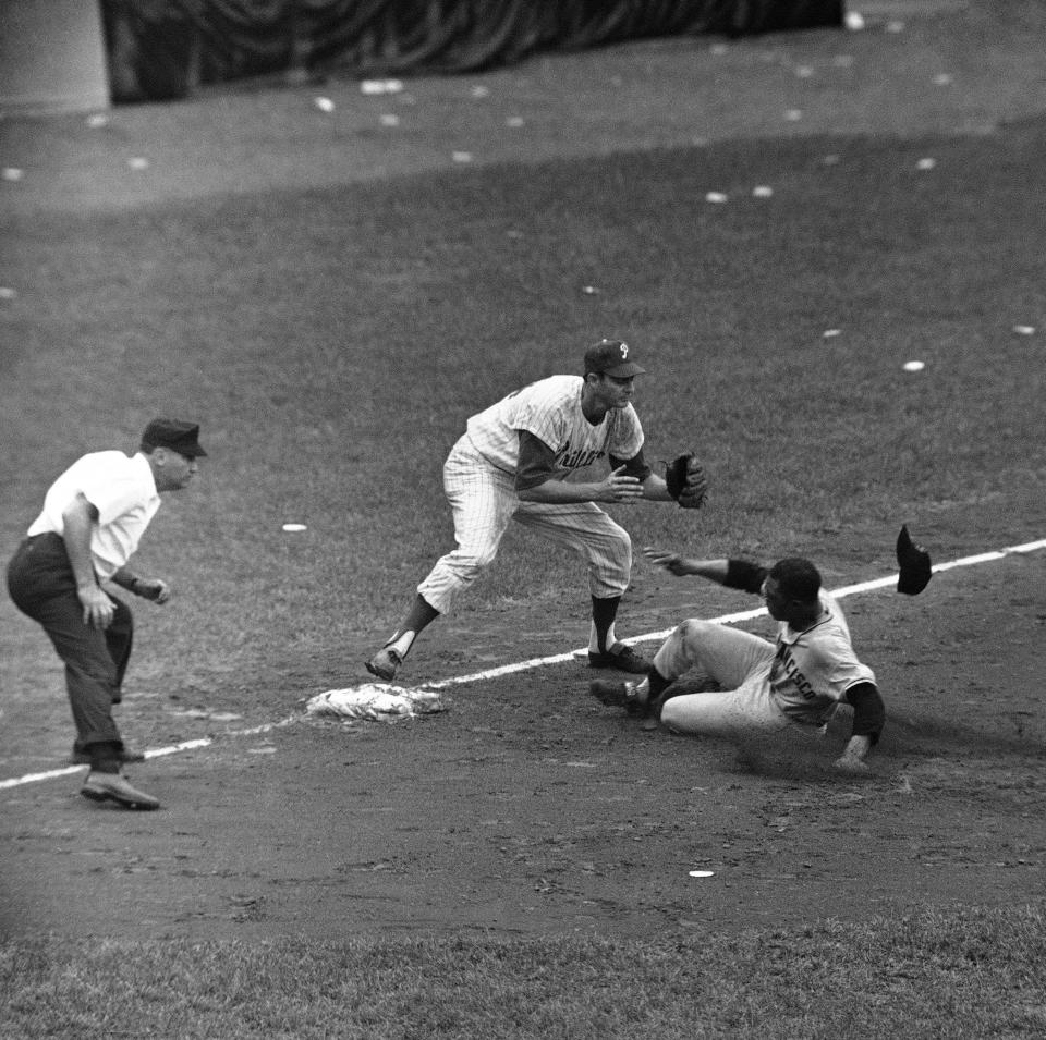 Willie Mays, San Francisco Giants outfielder, moves into third bass mines his hat in the seventh inning at Connie Mack Stadium on July 14, 1962 in Philadelphia. Mays advanced to third on Harvey Kuenn?s fly out to Phillies outfielder Tony Gonzalez. Don Demeter, Phillies third baseman waits the ball. Philadelphia won 6-5 in ten innings. (AP Photo)