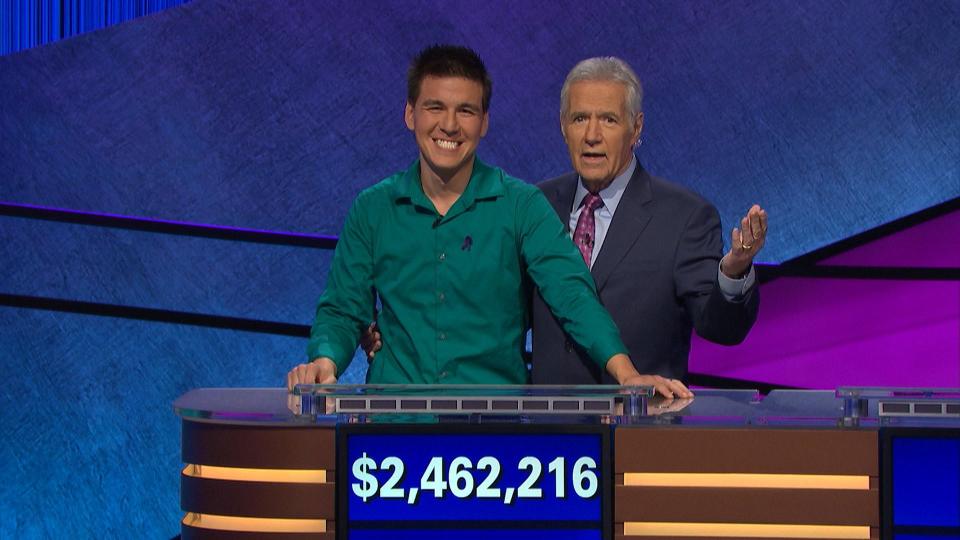 "Jeopardy!" host Alex Trebek, right, shares a moment with the brainy quiz show's recent long-running champ, James Holzhauer.