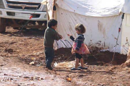 Children play outside tents housing internally displaced people in Atma camp, near the Syrian-Turkish border in Idlib Governorate, February 5, 2016. REUTERS/Ammar Abdullah