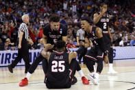 <p>Jose Perez #5 and Jaheam Cornwall #1 of the Gardner Webb Runnin Bulldogs help DJ Laster #25 up after a play in the first half against the Virginia Cavaliers during the first round of the 2019 NCAA Men’s Basketball Tournament at Colonial Life Arena on March 22, 2019 in Columbia, South Carolina. (Photo by Streeter Lecka/Getty Images) </p>