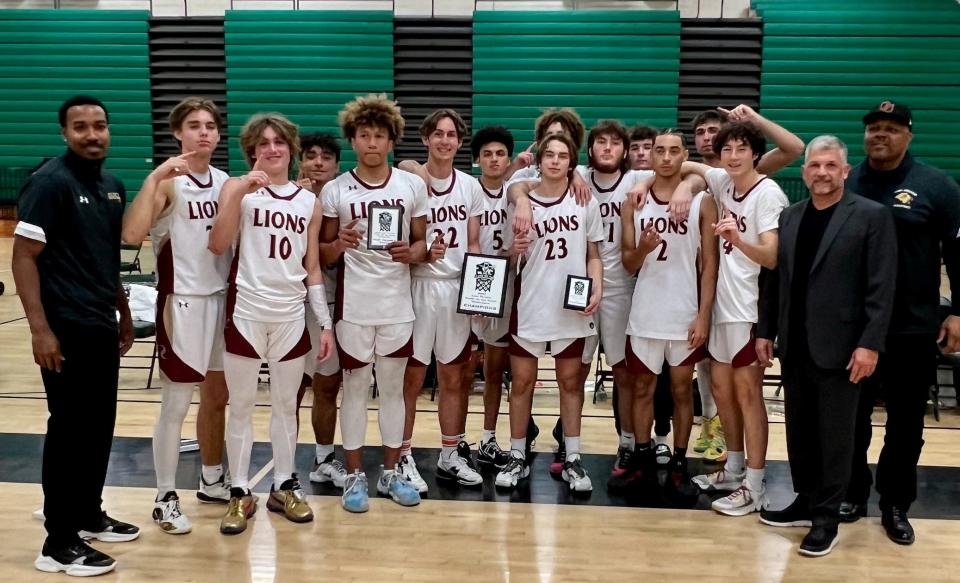 The Oaks Christian boys basketball team poses for a photo after beating Heritage Christian in the championship game of the King Triton's Clash on the Coast Tournament at Pacifica High on Saturday. The Lions improved to 10-0.