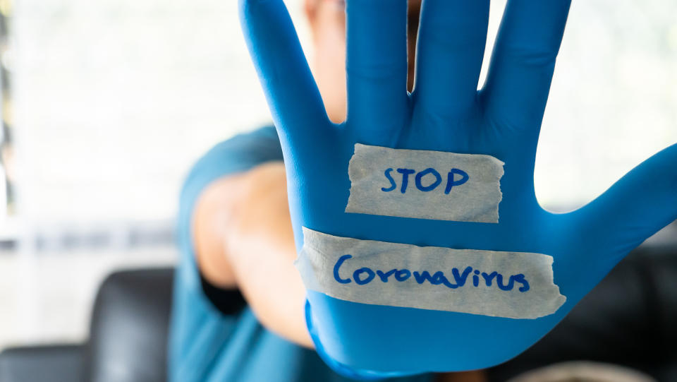 The glove-wearer has a message to stop the Coronavirus