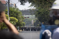 Protesters monitor as police is deployed during an anti-coup protest march in Yangon, Myanmar, Monday, March 1, 2021. Defiant crowds returned to the streets of the country's biggest city on Monday, determined to continue their protests against the military's seizure of power a month ago, despite security forces having killed at least 18 people around the country just a day earlier. (AP Photo)