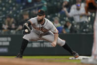 San Francisco Giants first baseman Brandon Belt catches the throw for the out on a grounder by Seattle Mariners' J.P. Crawford during the fourth inning of a baseball game Saturday, April 3, 2021, in Seattle. (AP Photo/Ted S. Warren)