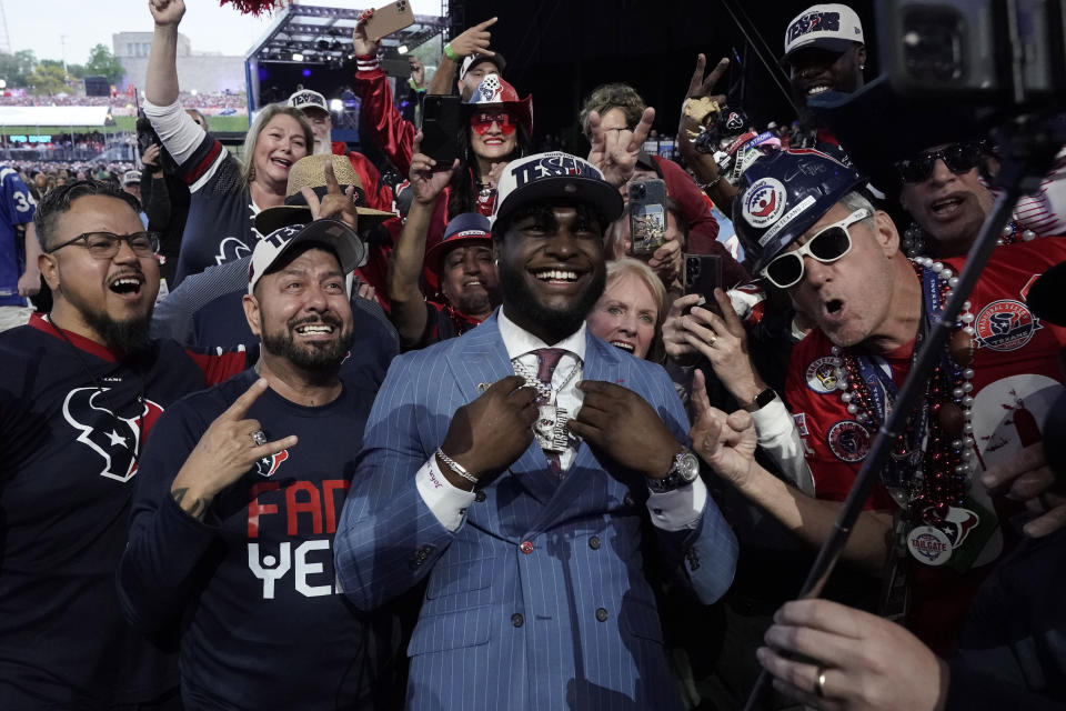 Alabama linebacker Will Anderson Jr. celebrates with fans after being chosen by the Houston Texans with the third overall pick during the first round of the NFL football draft, Thursday, April 27, 2023, in Kansas City, Mo. (AP Photo/Charlie Riedel)