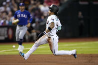 Arizona Diamondbacks' Ketel Marte advances safely to third on fly out hit by Tommy Pham a during the fourth inning of a baseball game against the Texas Rangers, Monday, Aug. 21, 2023, in Phoenix. (AP Photo/Matt York)