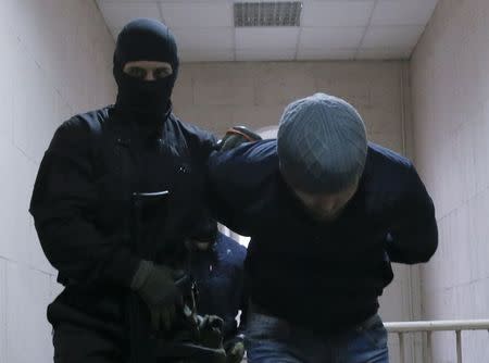 Anzor Gubashev, detained over the killing of Boris Nemtsov, is escorted inside a court building in Moscow, March 8, 2015. REUTERS/Maxim Shemetov