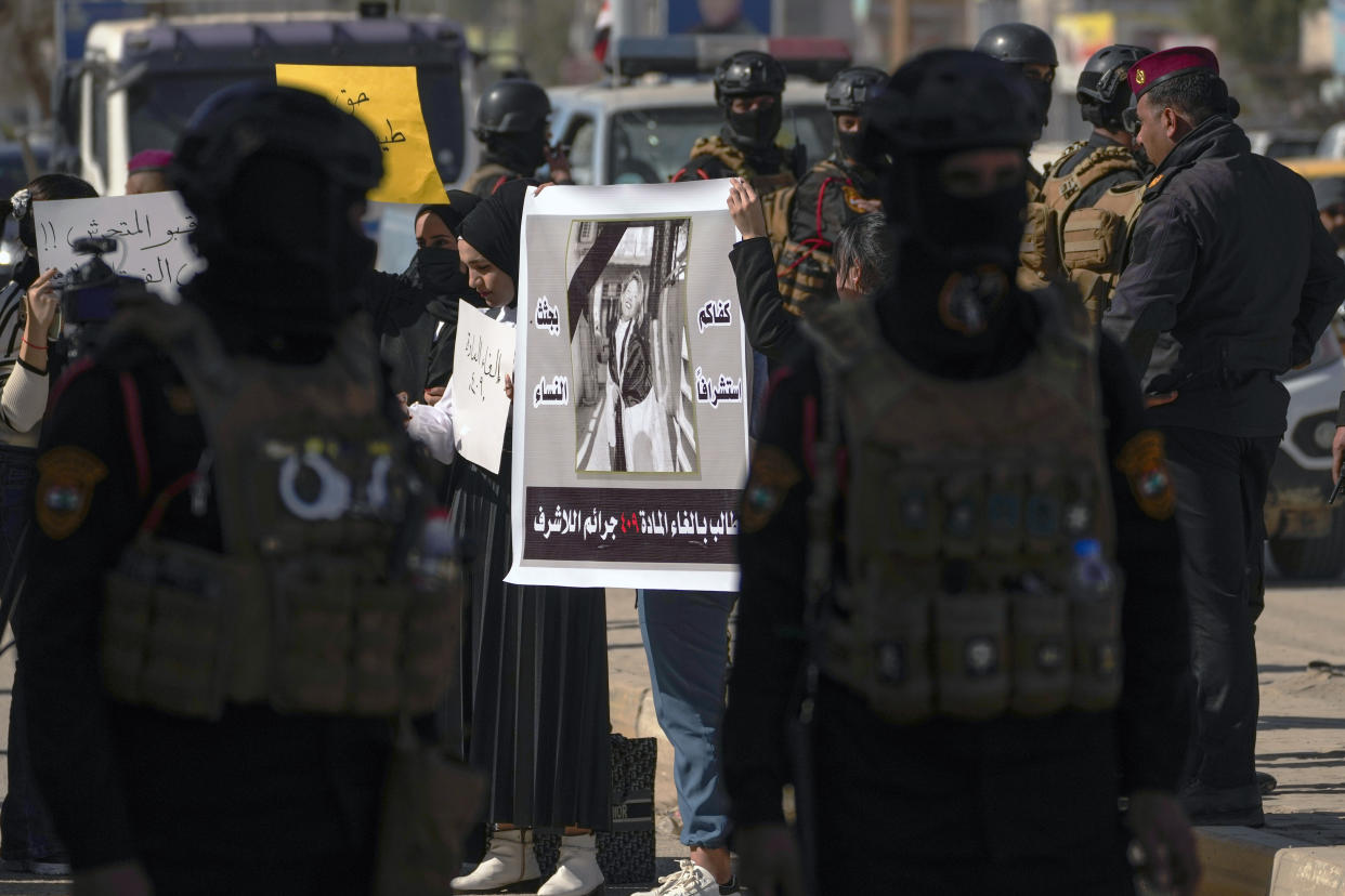 Demonstrators hold a poster with a picture of Tiba Ali, a YouTube star who was recently killed by her father, in Diwaniya, Iraq, Sunday, Feb. 5, 2023. Iraq's Interior Ministry spokesman Saad Maan on Friday announced that Tiba Ali was killed by her father on Jan. 31, who then turned himself into the police. (AP Photo/Hadi Mizban)