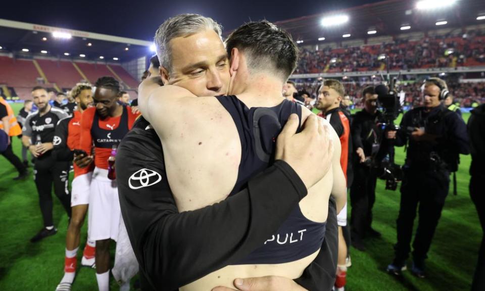 Barnsley manager Michael Duff hugs Liam Kitching after the playoff semi-final second leg against Bolton