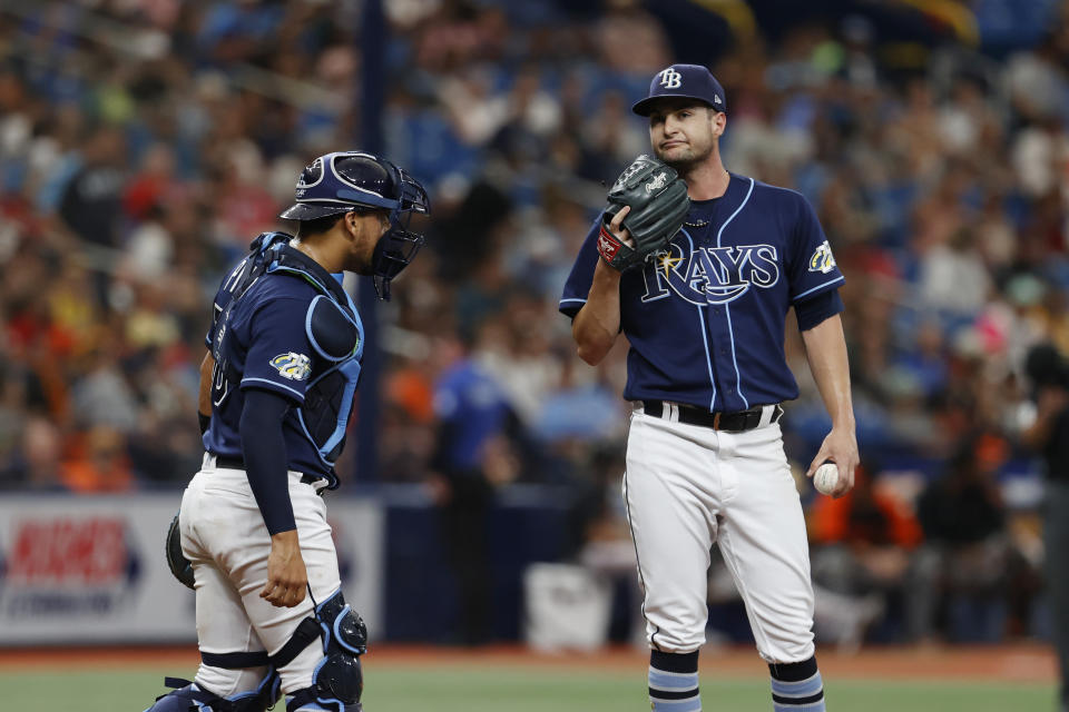 Tampa Bay Rays starting pitcher Shane McClanahan, right waits to talk with catcher Rene Pinto during the fourth inning of a baseball game against the Baltimore Orioles Saturday, July 22, 2023, in St. Petersburg, Fla. (AP Photo/Scott Audette)