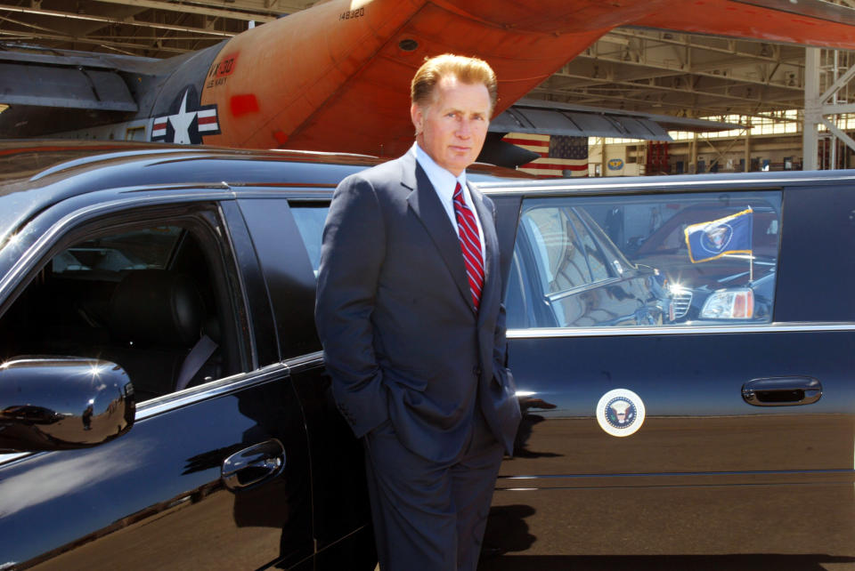 Martin Sheen as President Josiah Bartlet standing at his limo with the presidential seal