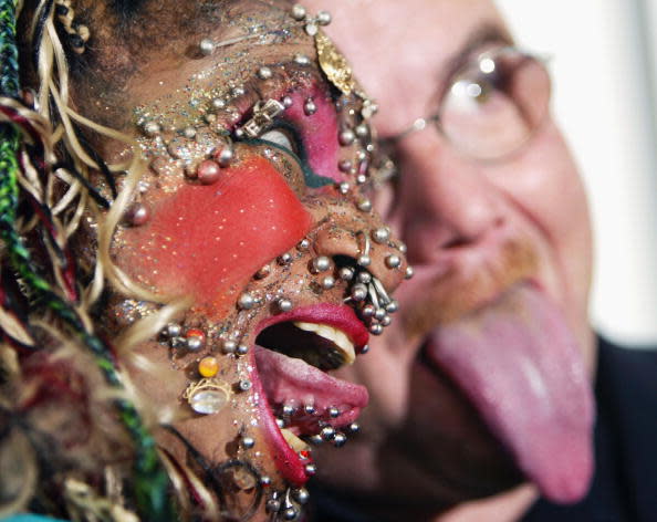 LONDON - NOVEMBER 11: Worlds most pierced woman Elaine Davidson and man with longest tongue Stephan Taylor pose for photographers at the photocall for the 100 millionth copy of the Guinness World Records in the Tate Modern on November 11, 2003, in London. (Photo by Bruno Vincent/Getty Images)