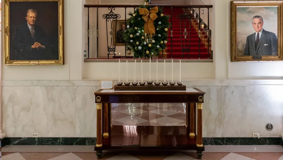 Menorah created by the Executive Residence Carpentry Shop from wood removed from the White House in the 1950s, as featured in the 2022 White House Holiday Decor.  