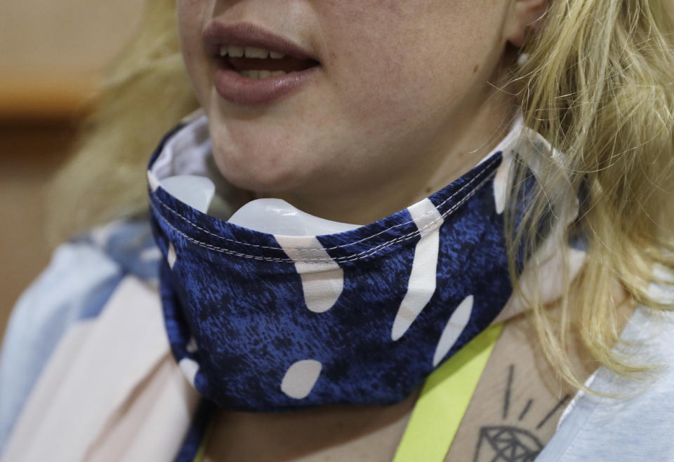 An employee wears the Wair Active connected wearable air purifier during CES Unveiled before CES International, Tuesday, Jan. 3, 2017, in Las Vegas. The smart air filter scarf will alert you when you are in an area with poor air quality and should be wearing the device. (AP Photo/John Locher)