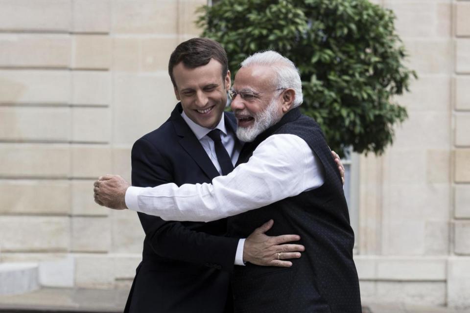 World leaders: French President Emmanuel Macron is hugged by PM Modi during a visit to Paris. (AP)