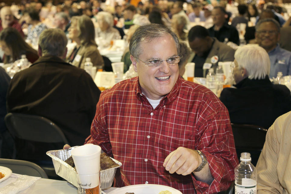 In this Saturday, Jan. 11, 2014 photo, U.S. Sen. Mark Pryor, D-Ark., holds a pan of raccoon meat at the Gillett Coon Supper in Gillett, Ark. Pryor faces a challenge from Republican Tom Cotton in the 2014 election. (AP Photo/Danny Johnston)