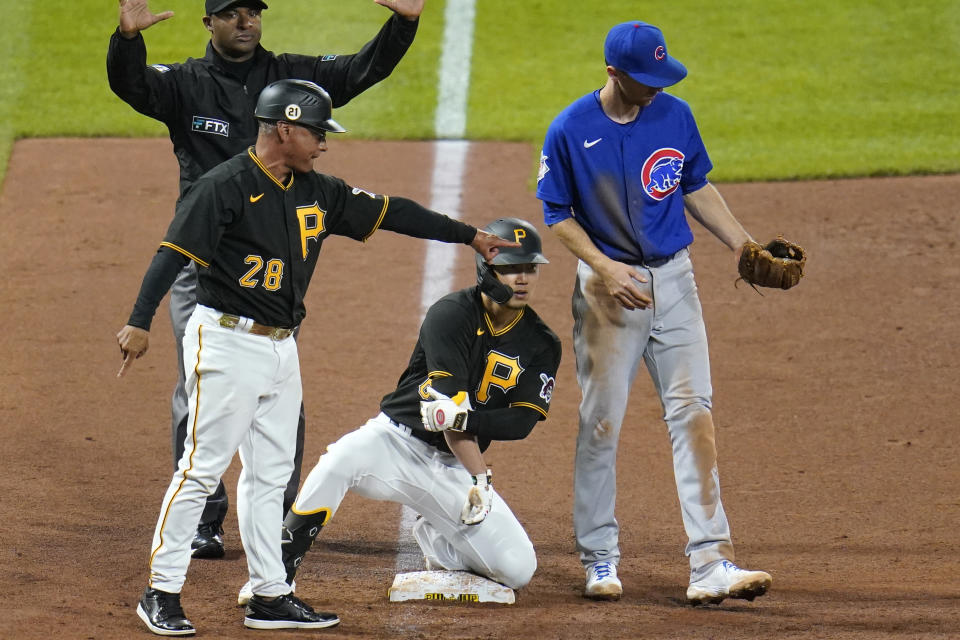 Pittsburgh Pirates' Hoy Park, center, kneels on third base after driving in two runs with a triple off Chicago Cubs relief pitcher Adam Morgan during the sixth inning of a baseball game in Pittsburgh, Tuesday, Sept. 28, 2021. (AP Photo/Gene J. Puskar)