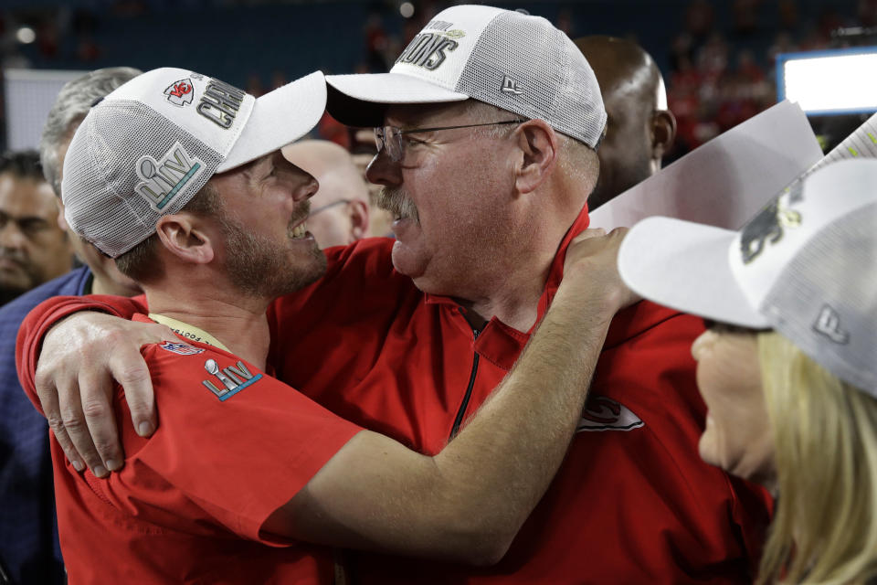 Kansas City Chiefs head coach Andy Reid embraces his son and is son Britt Reid, linebacker coach, after the NFL Super Bowl 54 football game, against the San Francisco 49ers, Sunday, Feb. 2, 2020, in Miami Gardens, Fla. The Kansas City Chiefs won 31-20. (AP Photo/Patrick Semansky)