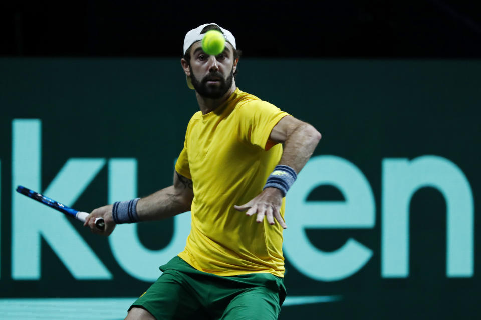 Australia's Jordan Thompson returns the ball to Netherland's Tallon Griekspoor during a Davis Cup quarter-final tennis match between Australia and The Netherlands in Malaga, Spain, Tuesday, Nov. 22, 2022. (AP Photo/Joan Monfort)