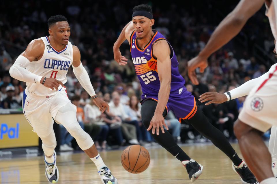 Phoenix Suns forward Darius Bazley (55) drives past Los Angeles Clippers guard Russell Westbrook (0) during a game on April 9, 2023, at Footprint Center in Phoenix.