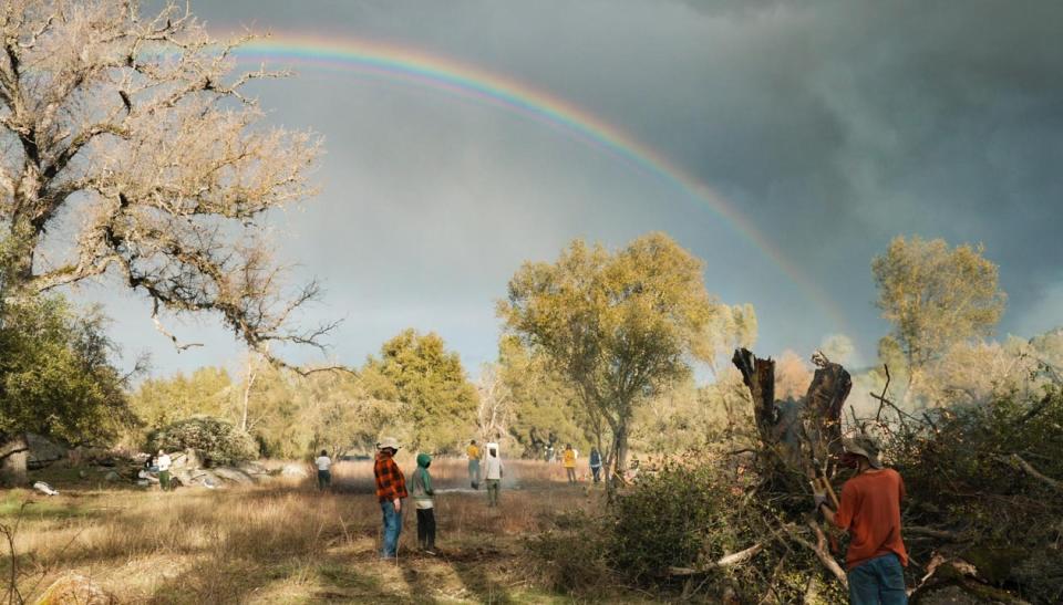 Once the rain stops, a rainbow forms over the property in Mariposa, California, as volunteers finish up the first day of work. (Photo: Ed Kashi/VII)