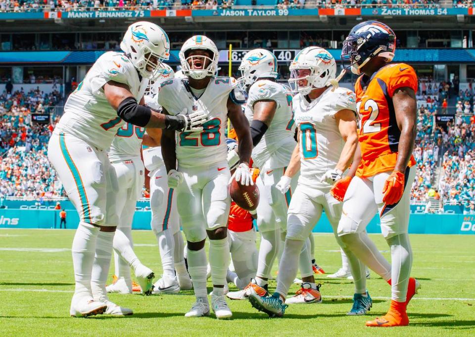Miami Dolphins running back De’Von Achane (28) celebrates with teammates after scoring a touchdown against the Denver Broncos during first quarter of an NFL football game at Hard Rock Stadium on Sunday, Sept. 24, 2023 in Miami Gardens, Fl.