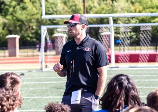 Chris Smelley, the head football coach at Sylacauga High School, coaching his team