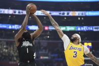Los Angeles Clippers guard James Harden, left, shoots as Los Angeles Lakers forward Anthony Davis defends during the first half of an NBA basketball game Wednesday, Feb. 28, 2024, in Los Angeles. (AP Photo/Mark J. Terrill)