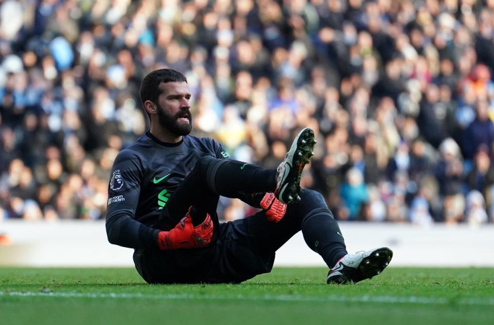 Alisson appeared to injure himself after clearing the ball (PA)