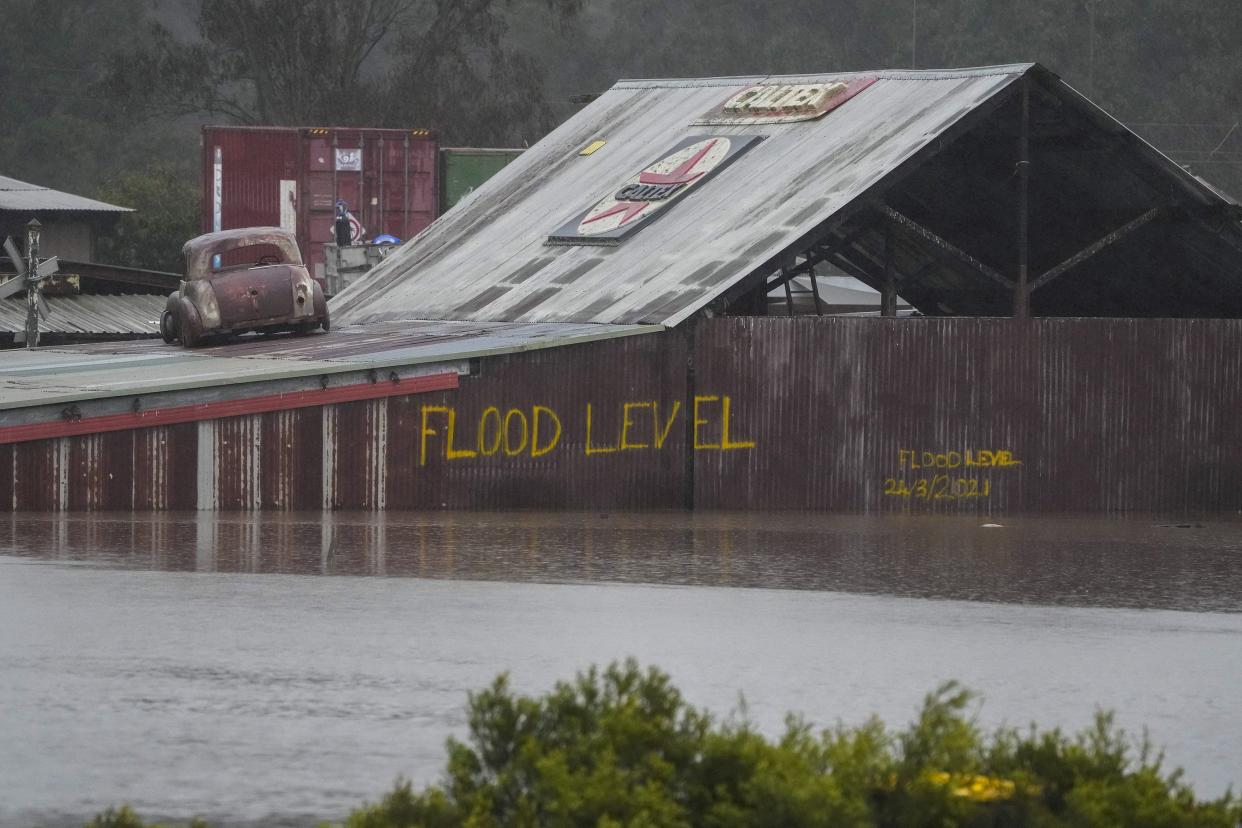 Flood waters surround an industrial property in Londonderry on the outskirts of Sydney, Australia, Monday, July 4, 2022. More than 30,000 residents of Sydney and its surrounds have been told to evacuate or prepare to abandon their homes on Monday as Australia's largest city braces for what could be its worst flooding in 18 months.