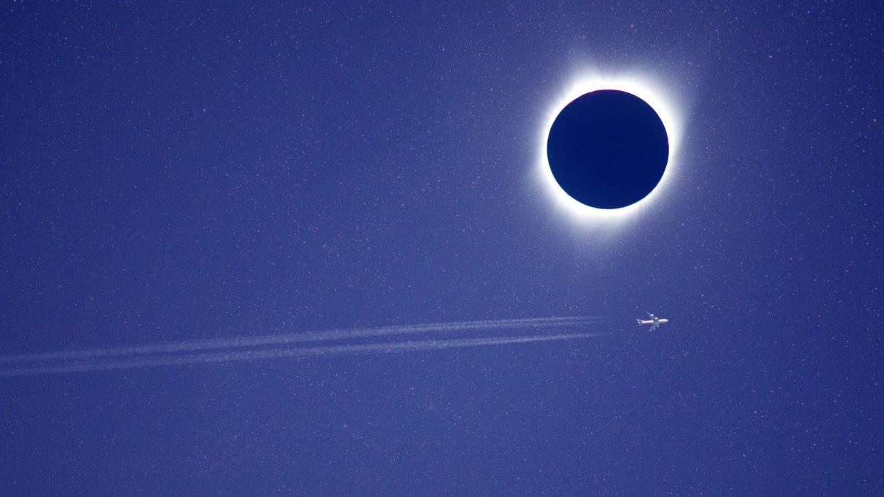  Passenger jet passing across total solar eclipse. 