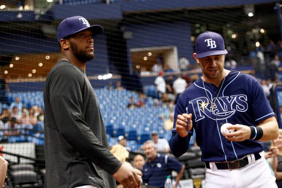 ST. PETERSBURG, FL - MAY 22:  O.J. Howard (L) of the Tampa Bay Buccaneers hands an autographed baseball to Evan Longoria #3 of the Tampa Bay Rays moments before throwing out the ceremonial first pitch before the start of a game between the Rays and the Los Angeles Angels on May 22, 2017 at Tropicana Field in St. Petersburg, Florida. (Photo by Brian Blanco/Getty Images)