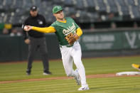 Oakland Athletics third baseman Tyler Nevin throws out Pittsburgh Pirates' Alika Williams at first base during the fourth inning of a baseball game in Oakland, Calif., Tuesday, April 30, 2024. (AP Photo/Jeff Chiu)