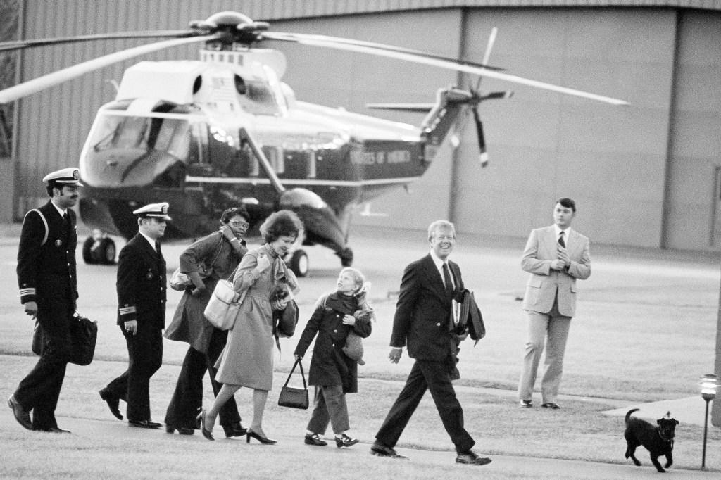 FILE President Jimmy Carter, second from right, arrives at Camp David, Md., with first lady Rosalynn Carter and daughter Amy Carter, center, on Friday, Feb. 25, 1977, along with Mary Fitzpatrick, Amy’s nursemaid, third from left, and two unidentified military aides as they walk toward the house at the presidential retreat in the Maryland mountains for the first time. Rosalynn Carter used her powerful posts to address injustices as her husband rose in politics, especially those imposed as part of the racist Jim Crow system that prevailed in Georgia. The most personal of those cases involved Mary Prince Fitzpatrick, who went to Washington as White House nanny to Amy Carter with a felony murder conviction still on her record. (AP Photo/Charles Tasnadi, File)