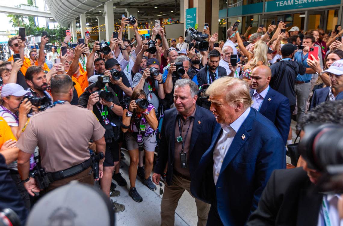 Former President Donald Trump is escorted by secret service ahead of Formula One Miami Grand Prix at the Miami International Autodrome on Sunday, May 5, 2024, in Miami Gardens, Fla.