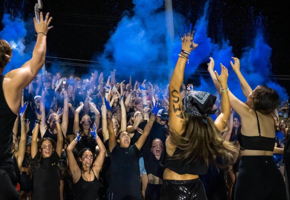 Casa Roble Rams student fans throw blue powder in the air to celebrate at the start of the second half against the Del Oro Golden Eagles at the high school football game Friday, Sept. 15, 2023, at Casa Roble High School in Orangevale.