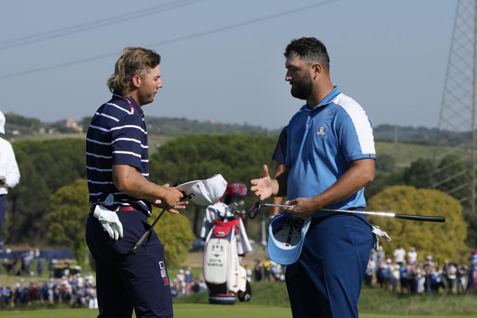 Europe's Jon Rahm, right, shakes hands with United States' Sam Burns after winning his morning Foursome match 4&3 at the Ryder Cup golf tournament at the Marco Simone Golf Club in Guidonia Montecelio, Italy, Friday, Sept. 29, 2023. (AP Photo/Alessandra Tarantino)