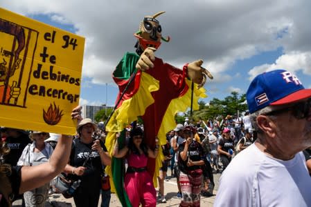 Demonstrators march during the national strike calling for the resignation of Governor Ricardo Rossello, in San Juan
