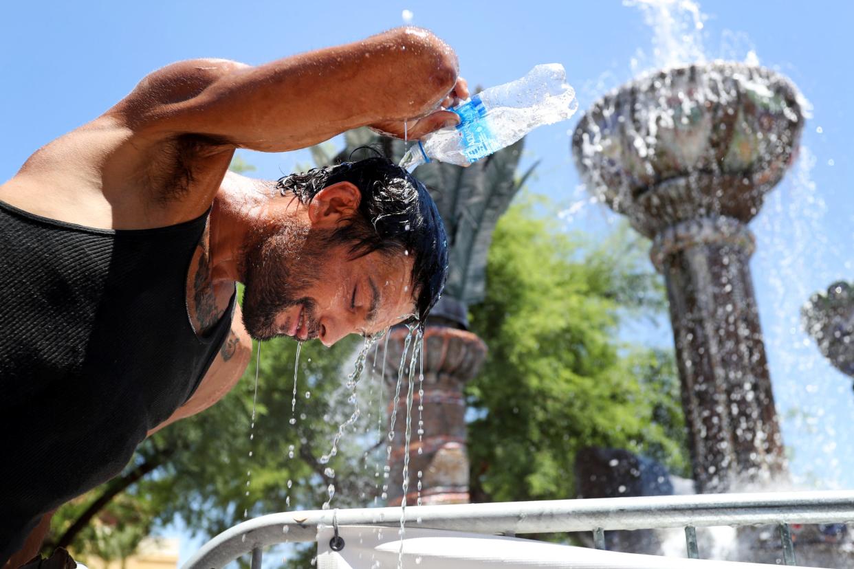 Vince Garcia, 35, of Palm Springs pours water over his head at the Fountain of Life in Cathedral City, Calif., on July 21, 2023. Temperatures in the Coachella Valley could reach 120 degrees. 