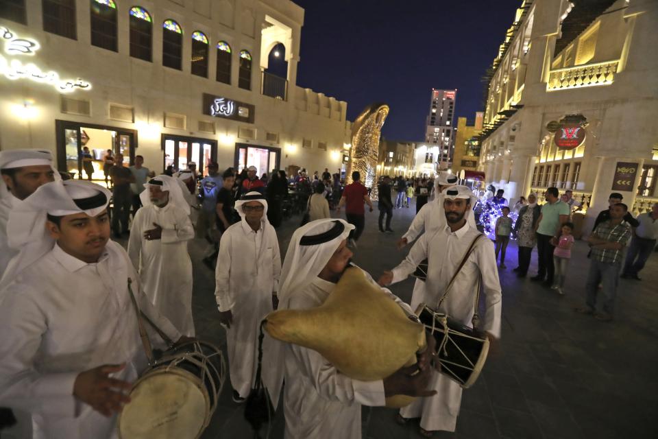 FILE - Qatari musicians perform traditional songs at Souq Waqif in Doha, Qatar, Thursday, April 25, 2019. Qatar is a devoutly apolitical place, with speech and assembly heavily restricted and a large population of foreign workers who could lose their livelihoods if they cause a stir. But that could change next month, when an estimated 1.2 million soccer fans descend on the tiny Gulf Arab nation for the World Cup. (AP Photo/Kamran Jebreili, File)