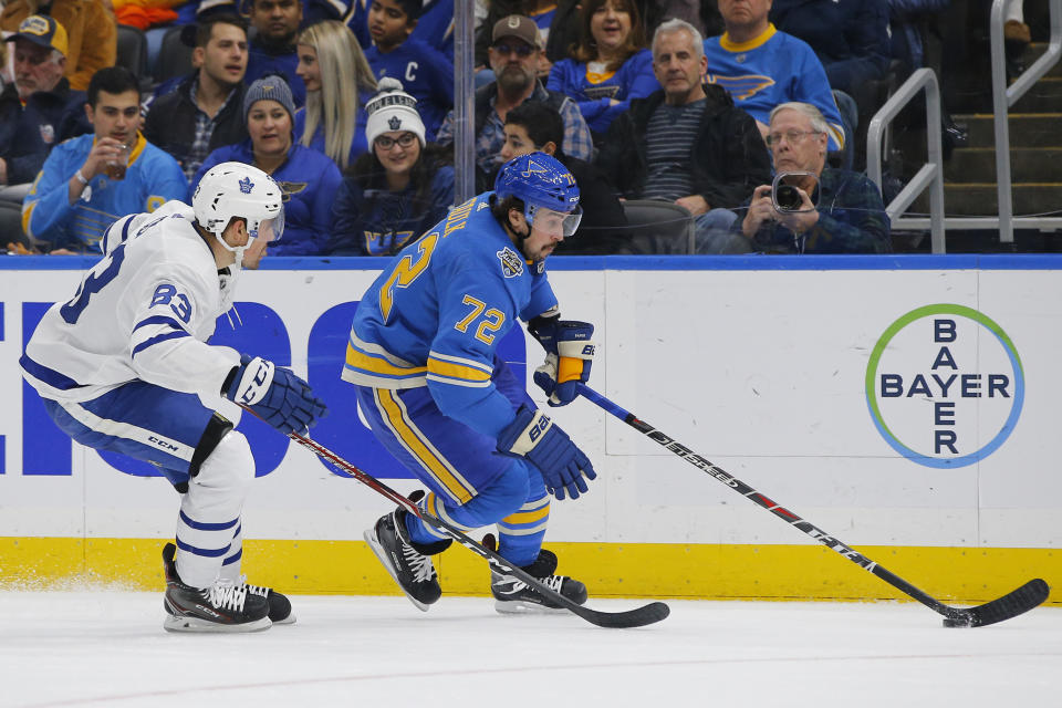 St. Louis Blues' Justin Faulk, right, skates with the puck as he is trailed by Toronto Maple Leafs' Cody Ceci during the second period of an NHL hockey game Saturday, Dec. 7, 2019, in St. Louis. (AP Photo/Billy Hurst)