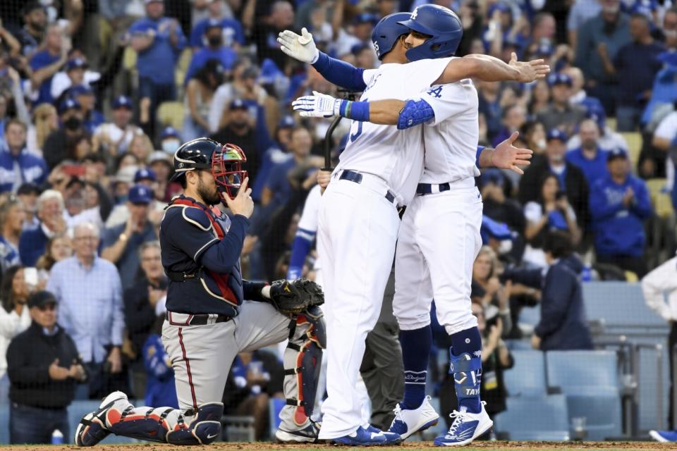 Dodgers' Chris Taylor hugs Albert Pujols after a two-run home run.