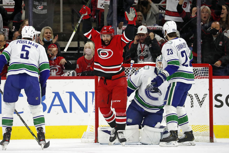 Carolina Hurricanes' Vincent Trocheck (16) celebrates a goal by teammate Sebastian Aho, not pictured, against the Vancouver Canucks during the first period of an NHL hockey game in Raleigh, N.C., Saturday, Jan. 15, 2022. (AP Photo/Karl B DeBlaker)