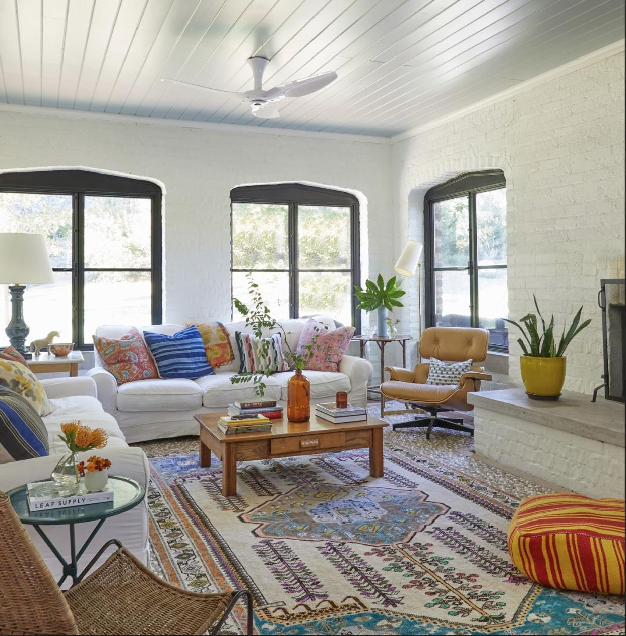 a living room with a rug and a coffee table