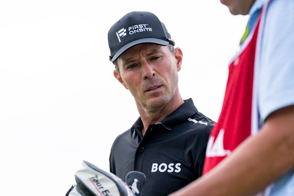 May 26, 2022; Benton Harbor, Michigan, USA; Mike Weir looks down at a yardage book from the eighth tee box during the first round of the 2022 KitchenAid Senior PGA Championship at Harbor Shores. Mandatory Credit: Raj Mehta-USA TODAY Sports